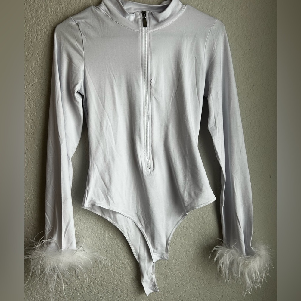 L white body suit with feather cuffs
